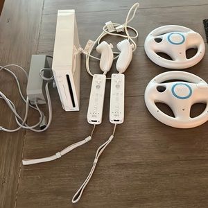Nintendo Wii console with power cord, game controllers and 2 steering wheels